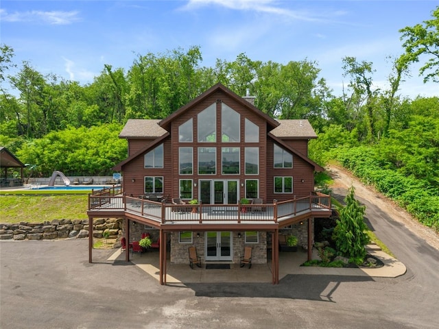 201 Roosevelt Rd, Kilbuck Twp, PA 15202 - rear view of house with a deck, a patio area, stone siding, and an outdoor pool