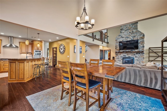 201 Roosevelt Rd, Kilbuck Twp, PA 15202 - dining space featuring dark wood finished floors, a fireplace, a chandelier, recessed lighting, and a towering ceiling