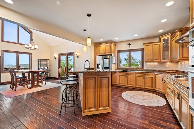 201 Roosevelt Rd, Kilbuck Twp, PA 15202 - kitchen featuring stainless steel fridge, a kitchen breakfast bar, healthy amount of natural light, glass insert cabinets, and recessed lighting
