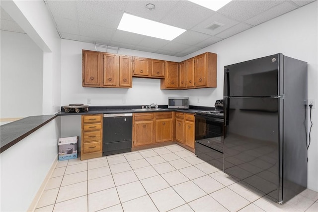 5 Bayard Rd Unit 808, Shadyside, PA 15213 - kitchen with black appliances, a drop ceiling, dark countertops, a sink, and brown cabinetry