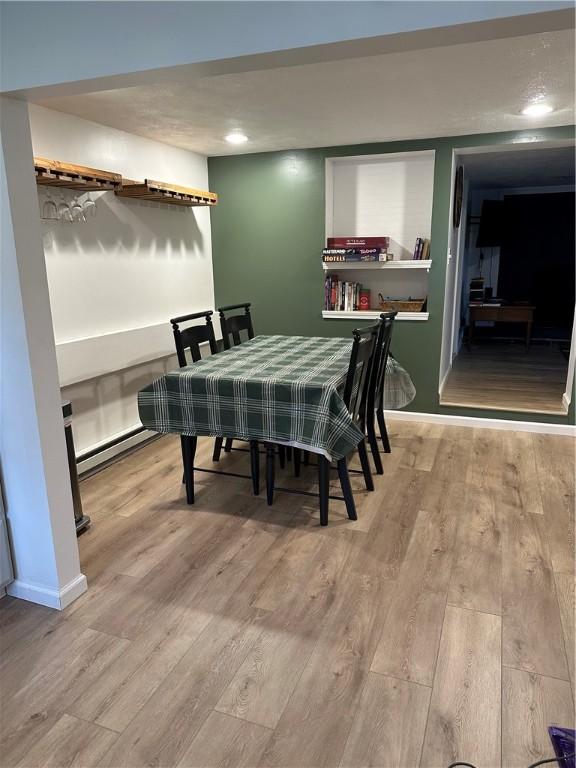 2057 Mccann Dr, Shenango, PA 16424 - dining room with baseboard heating, wood finished floors, and baseboards