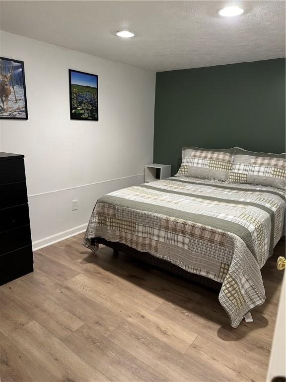 2057 Mccann Dr, Shenango, PA 16424 - bedroom with wood finished floors, recessed lighting, and baseboards
