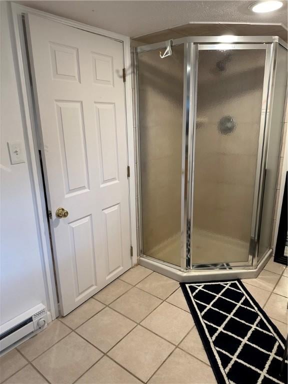 2057 Mccann Dr, Shenango, PA 16424 - bathroom featuring a baseboard radiator, tile patterned floors, and a shower stall
