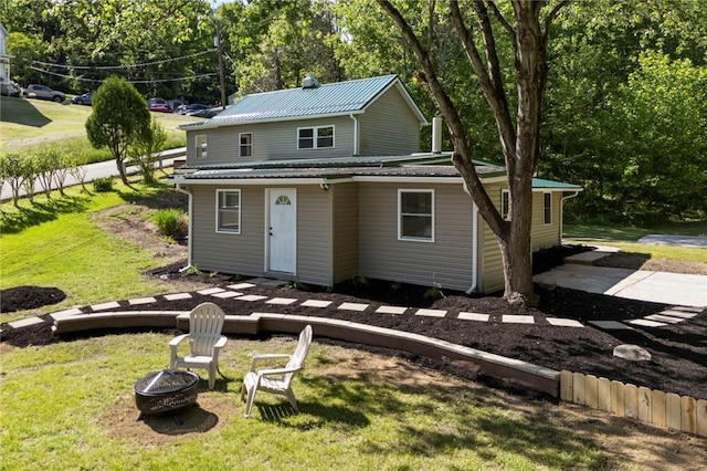 470 Burrell Hill Cir, Penn Twp Wml, PA 15675 - view of front facade with a fire pit, a front yard, and view of scattered trees