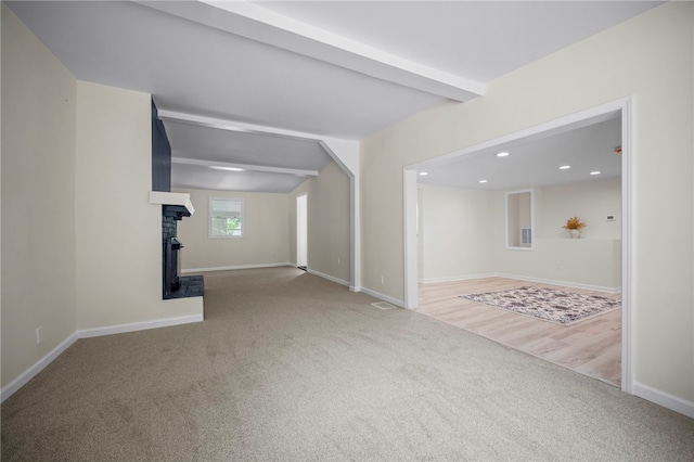 470 Burrell Hill Cir, Penn Twp Wml, PA 15675 - unfurnished living room with carpet, baseboards, a fireplace with raised hearth, recessed lighting, and beamed ceiling