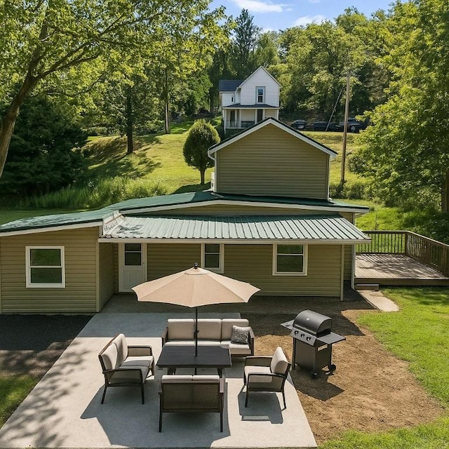 470 Burrell Hill Cir, Penn Twp Wml, PA 15675 - rear view of house with an outdoor hangout area, a wooden deck, a patio, metal roof, and view of scattered trees