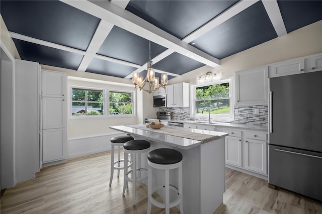 470 Burrell Hill Cir, Penn Twp Wml, PA 15675 - kitchen with stainless steel appliances, a chandelier, coffered ceiling, plenty of natural light, and a sink