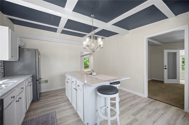 470 Burrell Hill Cir, Penn Twp Wml, PA 15675 - kitchen with a kitchen island, white cabinets, a breakfast bar, coffered ceiling, and light wood-style floors