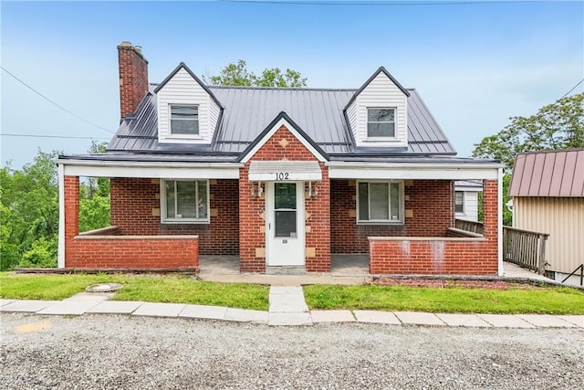 102 Payne Hill Rd, Jefferson Hills, PA 15025 - view of front of house featuring brick siding, a porch, a chimney, and metal roof
