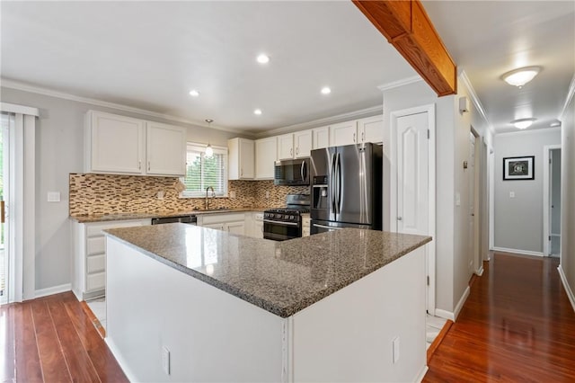 116 Buttercup Dr, Cranberry Twp, PA 16066 - kitchen featuring stainless steel appliances, crown molding, wood finished floors, tasteful backsplash, and a sink
