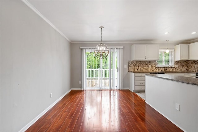 116 Buttercup Dr, Cranberry Twp, PA 16066 - kitchen with a chandelier, decorative backsplash, baseboards, ornamental molding, and white cabinets