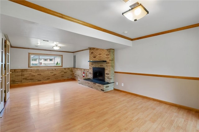 116 Buttercup Dr, Cranberry Twp, PA 16066 - unfurnished living room featuring ornamental molding, light wood-type flooring, a brick fireplace, french doors, and baseboards