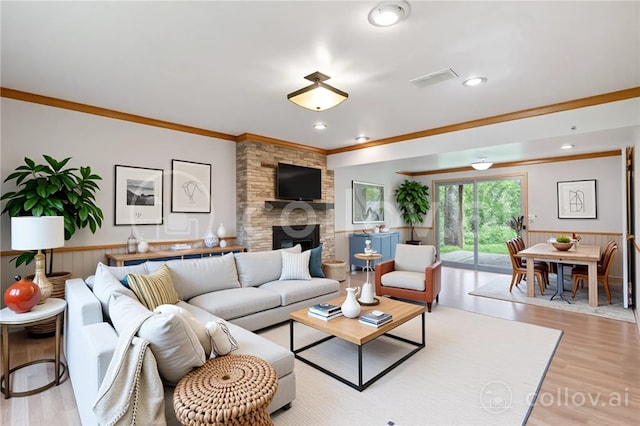 116 Buttercup Dr, Cranberry Twp, PA 16066 - living area featuring crown molding, a wainscoted wall, wood finished floors, a large fireplace, and recessed lighting