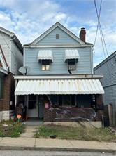 615 Margaret St, Mount Oliver, PA 15210 - view of front of house featuring a chimney