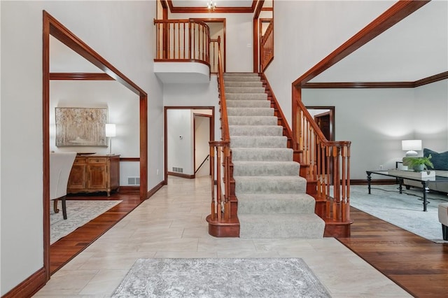 5010 W Grove Ln, Pine Twp Nal, PA 15044 - entryway featuring crown molding, stairs, a high ceiling, and baseboards