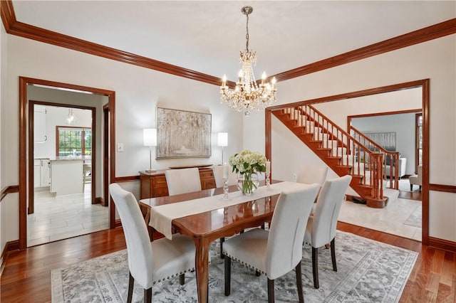 5010 W Grove Ln, Pine Twp Nal, PA 15044 - dining area with a chandelier, crown molding, stairway, baseboards, and wood finished floors