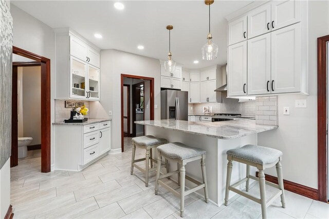 5010 W Grove Ln, Pine Twp Nal, PA 15044 - kitchen with stainless steel refrigerator with ice dispenser, decorative backsplash, a peninsula, light stone countertops, and white cabinets