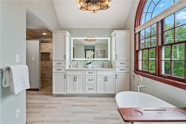 5010 W Grove Ln, Pine Twp Nal, PA 15044 - bathroom featuring a chandelier, vaulted ceiling, double vanity, tiled shower, and a freestanding tub