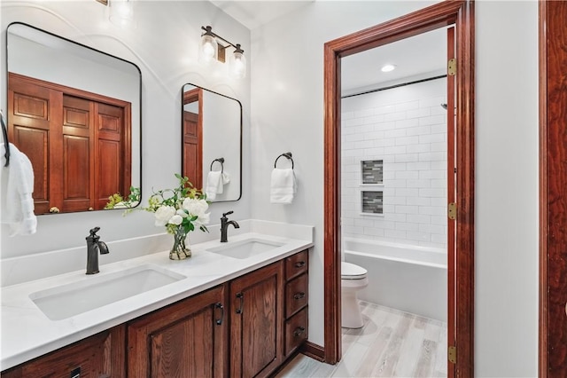 5010 W Grove Ln, Pine Twp Nal, PA 15044 - bathroom featuring toilet, double vanity, wood finished floors, and shower / washtub combination