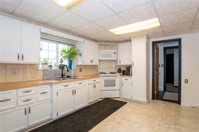 10 N St, Smith, PA 15004 - kitchen featuring a sink, white appliances, white cabinets, light countertops, and a drop ceiling