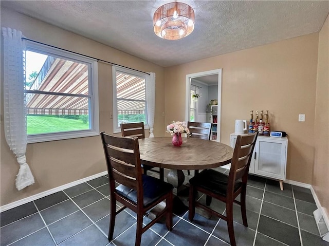 145 Marylee Dr, Brighton Twp, PA 15009 - dining area with a textured ceiling, dark tile patterned floors, and baseboards