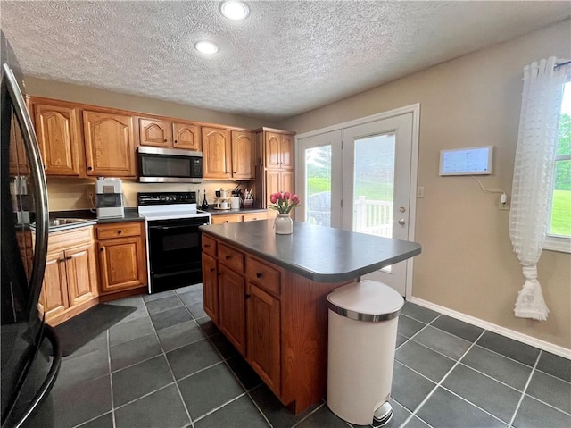145 Marylee Dr, Brighton Twp, PA 15009 - kitchen featuring stainless steel microwave, electric range, plenty of natural light, a textured ceiling, and recessed lighting