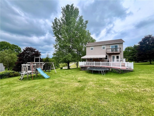 145 Marylee Dr, Brighton Twp, PA 15009 - view of green lawn featuring a trampoline, a playground, and a wooden deck