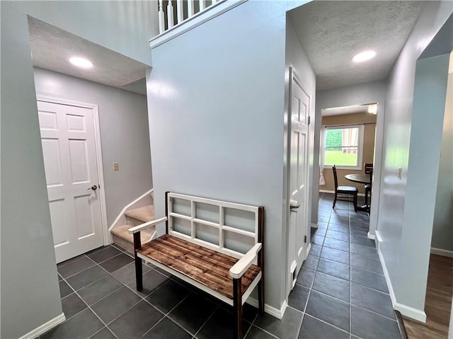 145 Marylee Dr, Brighton Twp, PA 15009 - hall featuring dark tile patterned flooring, a textured ceiling, and baseboards