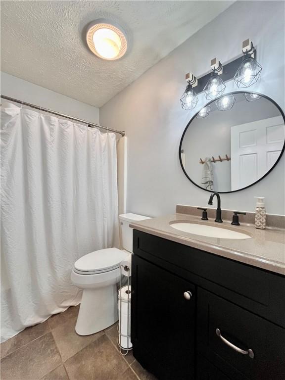 145 Marylee Dr, Brighton Twp, PA 15009 - full bathroom with vanity, toilet, a textured ceiling, and a shower with curtain