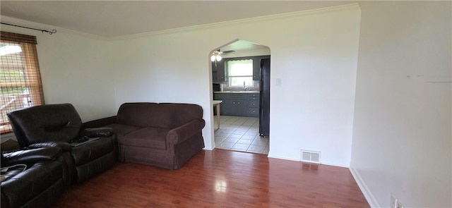 27 Elich Rd, Pa, PA 15021 - living area with wood finished floors, ceiling fan, crown molding, arched walkways, and baseboards