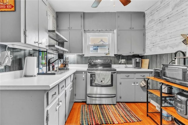 122 W Main St, Worthington, PA 16262 - kitchen with stainless steel electric stove, gray cabinetry, ceiling fan, light countertops, and light wood-style floors