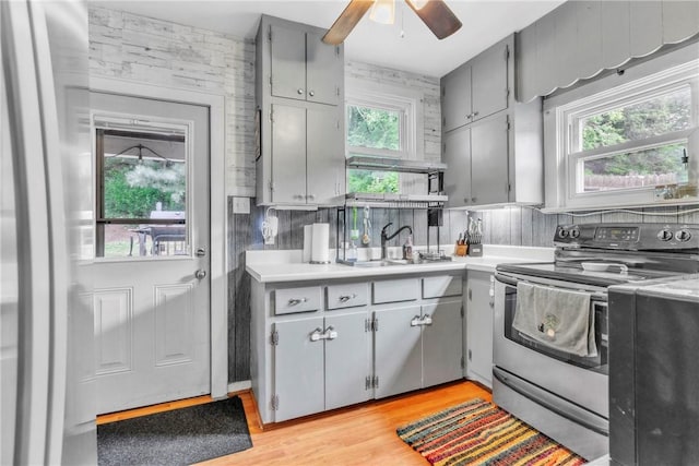 122 W Main St, Worthington, PA 16262 - kitchen featuring appliances with stainless steel finishes, gray cabinetry, a ceiling fan, a sink, and light wood-style flooring