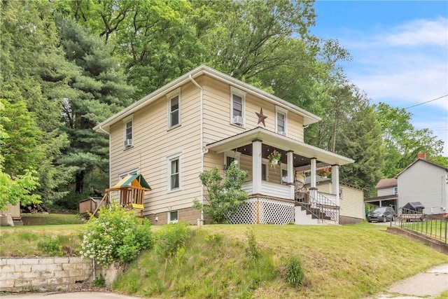 122 W Main St, Worthington, PA 16262 - american foursquare style home featuring covered porch, a front lawn, and a playground