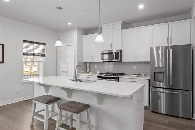 9002 Hickory Rd, Pine Twp Nal, PA 15044 - kitchen with appliances with stainless steel finishes, a sink, tasteful backsplash, dark wood-style flooring, and light countertops