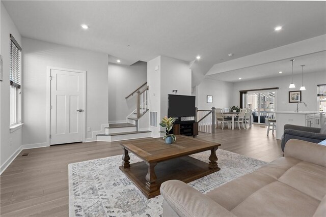 9002 Hickory Rd, Pine Twp Nal, PA 15044 - living area featuring light wood-type flooring, stairway, recessed lighting, and baseboards