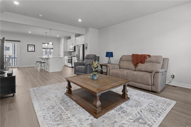 9002 Hickory Rd, Pine Twp Nal, PA 15044 - living room with light wood-type flooring, recessed lighting, and baseboards