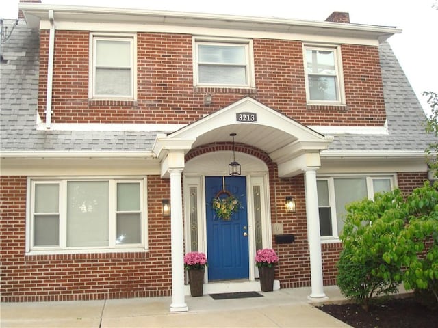 3213 Brownsville Rd, Brentwood, PA 15227 - entrance to property with brick siding, a shingled roof, and a chimney