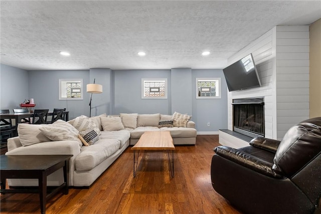 1904 E National Pike, North Bethlehem, PA 15360 - living room with a textured ceiling, hardwood / wood-style floors, a large fireplace, recessed lighting, and baseboards