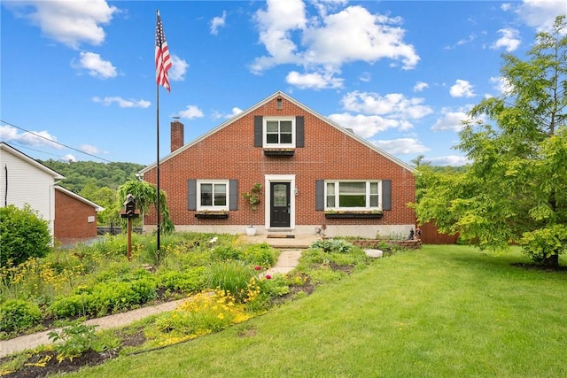 1904 E National Pike, North Bethlehem, PA 15360 - view of front of home featuring a front lawn, a chimney, and brick siding