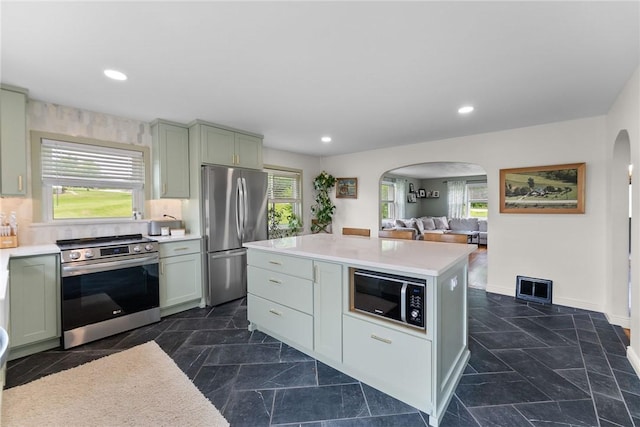 1904 E National Pike, North Bethlehem, PA 15360 - kitchen with stainless steel appliances, arched walkways, light countertops, recessed lighting, and a kitchen island