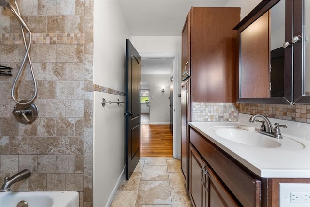 1904 E National Pike, North Bethlehem, PA 15360 - bathroom featuring vanity, shower / bath combination, stone tile floors, backsplash, and baseboards
