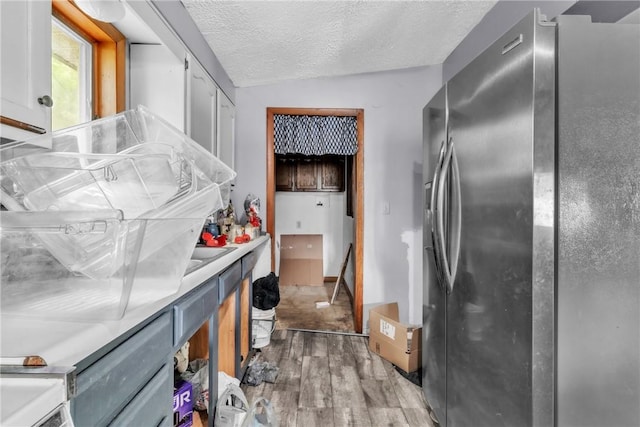 408 Mitchell Ave, City Of But Nw, PA 16001 - kitchen featuring stainless steel refrigerator with ice dispenser, light wood-style floors, light countertops, white cabinetry, and a textured ceiling