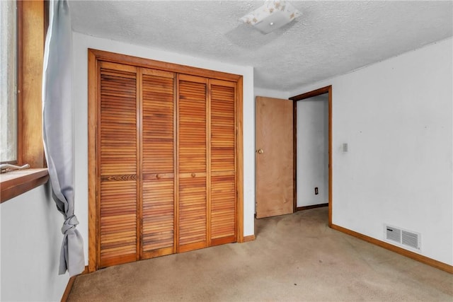 408 Mitchell Ave, City Of But Nw, PA 16001 - unfurnished bedroom featuring a closet, light carpet, baseboards, and a textured ceiling
