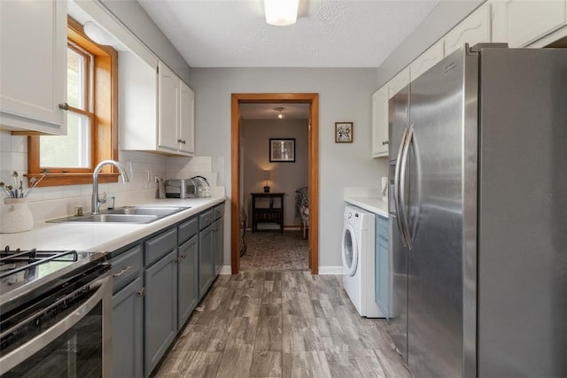 408 Mitchell Ave, City Of But Nw, PA 16001 - kitchen with stainless steel fridge, wood finished floors, gray cabinetry, white cabinetry, and light countertops