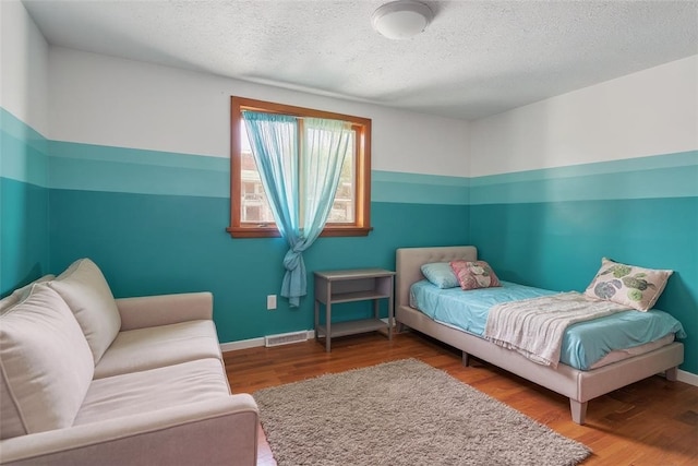 408 Mitchell Ave, City Of But Nw, PA 16001 - bedroom featuring wood finished floors and a textured ceiling