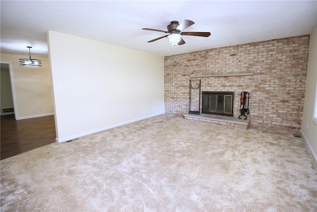2224 Park Ave, Manor Twp, PA 16226 - unfurnished living room featuring carpet, baseboards, a brick fireplace, and ceiling fan