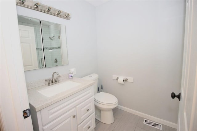 2224 Park Ave, Manor Twp, PA 16226 - bathroom featuring vanity, tiled shower, toilet, and baseboards