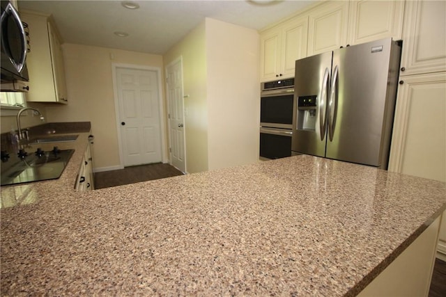 2224 Park Ave, Manor Twp, PA 16226 - kitchen with black appliances, light stone countertops, a sink, recessed lighting, and baseboards