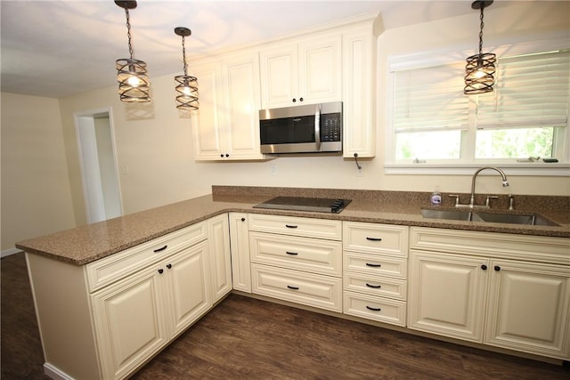 2224 Park Ave, Manor Twp, PA 16226 - kitchen featuring stainless steel microwave, a sink, black electric stovetop, pendant lighting, and dark stone counters