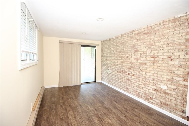 2224 Park Ave, Manor Twp, PA 16226 - empty room featuring brick wall, dark wood-style flooring, and baseboards